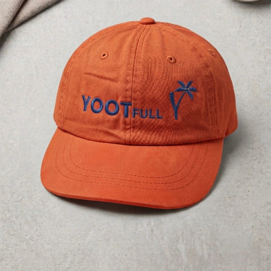 Orange cap with 'YOOT FULL' text and palm tree design on a light gray background